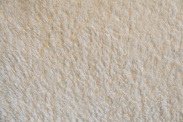 A close up of a white carpet with a fuzzy texture