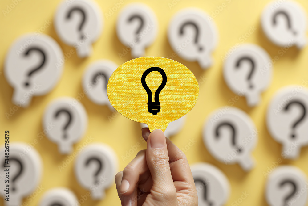 Poster yellow speech bubble with lightbulb icon held against blurred background of white speech bubbles wit