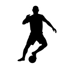 Silhouette of a soccer player striking a ball  
