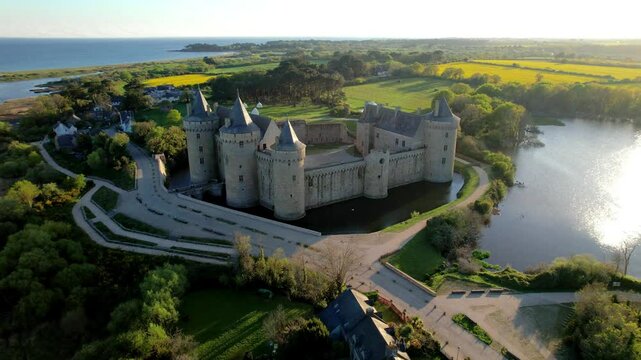 Brittany France tourism. Medieval Suscinio Castle at sunset aerial view. French chateau de Suscinio in Morbihan. Historic fortress architecture. Bretagne travel destination. Sarzeau coast drone 4K