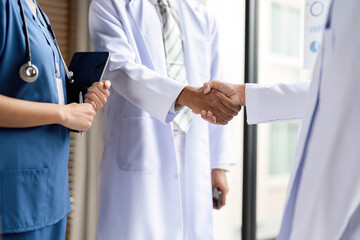 Healthcare Professionals Shaking Hands to Foster Collaboration