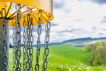 yellow disc golf basket on the left