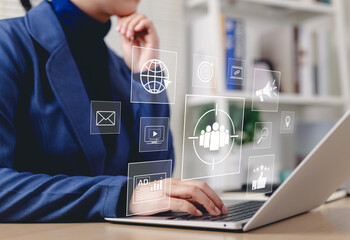 Digital Marketing Strategy and Target Audience Concept. Businessperson working on laptop with digital icons representing email, analytics, audience targeting, SEO, video, campaign, and online ads.