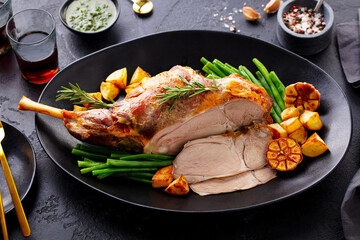 Roasted lamb leg with green bean and red wine. Grey background. Close up. © annapustynnikova