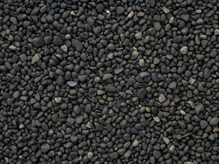 Earthy Texture: Close-up view of smooth, dark pebbles, offering a sense of natural textures.