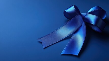 Blue ribbon bow on blue backdrop for gift, decor, or celebration