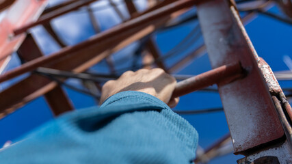 Climbing a communication tower with a view from first-person perspective