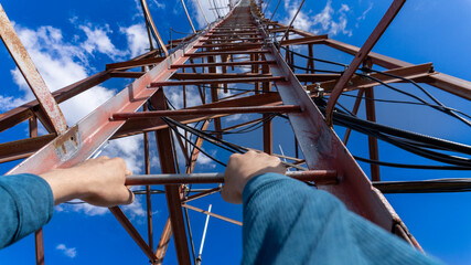 Climbing a communication tower with a view from first-person perspective