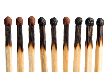 Burnt matches in a row demonstrating progression on black background