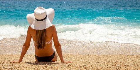 young woman sunbathing at the beach