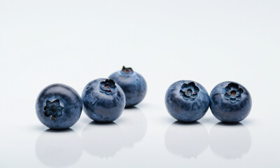 Fresh blueberries arranged on a clean white background, perfect for food photography or advertising