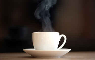 A steaming coffee cup placed on a rustic wooden table truly a delightful morning experience