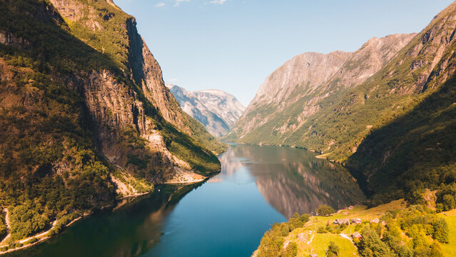 Golden light over dramatic cliffs of Geirangerfjord, Norway