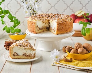 Round shortcrust pastry pie with apples, walnuts and sour cream soufflé on a cake stand against a light concrete background. Recipes apples.