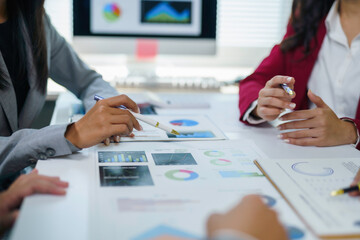 Business team analyzing financial charts and graphs discussing company strategy during a meeting