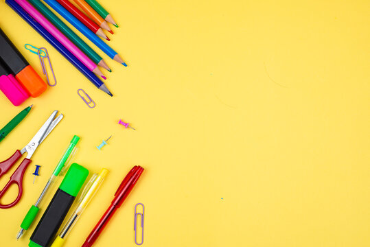 A Collection of Colorful Stationery Supplies Displayed Beautifully on a Bright Yellow Background