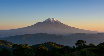 Majestic Snow-Capped Mountain at Dusk with Lush Green Hills