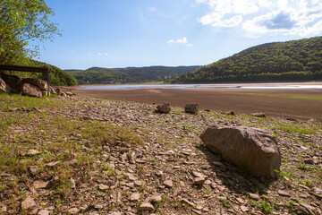 Exposed shoreline of Domaša reservoir during drought. Water level dropped far below the usual...