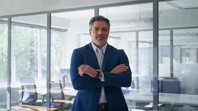 Portrait of indian or latin hispanic mature middle age boss, leader, ceo male businessman in suit in office workplace. Executive confident senior business man specialist looking at camera. Copy space