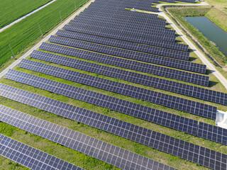 Aerial view of solar power station on a green field. Sustainable development