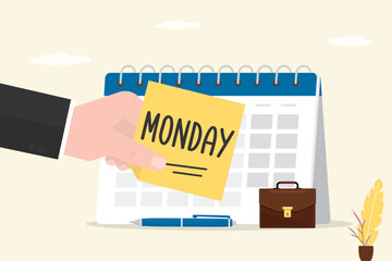 Monday morning. Start of the working week. Businessman hand sticks a note on calendar. Work week schedule. Monday routine office work