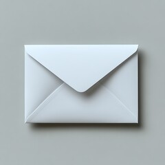 A plain white envelope lays on a smooth neutral surface