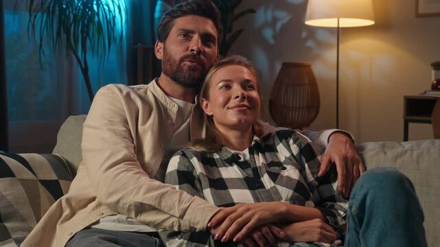 Relaxed Caucasian woman man love couple affectionate happy family at evening night insomnia talking husband wife together relax rest cuddling on couch sofa cozy home casual conversation romantic date
