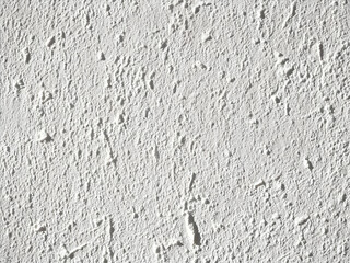 Obraz premium Close-up of white plaster with natural light. The textured surface includes imperfections, creating a calm and minimalistic backdrop for use in design.