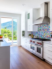 Modern Kitchen with Colorful Mosaic Backsplash and Mountain View - Bright, modern kitchen features a colorful mosaic backsplash, stainless steel appliances, white cabinetry