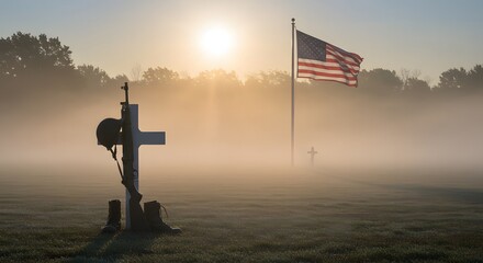 Rifle boots and helmet arranged in battlefield cross in peaceful misty field for respectful Veterans Day tribute