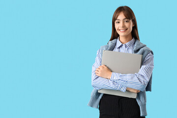 Young businesswoman with folder on blue background