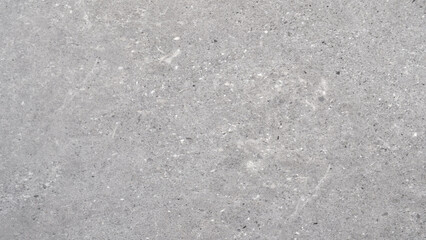 Fototapeta premium A grey background with a few black dots scattered around. dots are placed in various sizes and positions, creating a sense of depth and texture. overall effect is a somewhat chaotic.