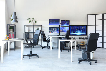Interior of trader's office with desks and shelf units