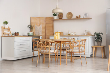 Stylish interior of kitchen with candles on dining table