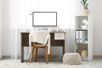 Modern home office with computer near window in room