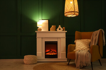 Interior of dark living room with fireplace, armchair and glowing lamps at night