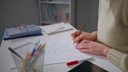 Unknown teacher checking homework at office desk closeup. Woman putting marks