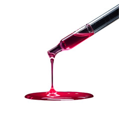 A close up of a pipette dripping a red liquid onto a black surface creating a small puddle below it