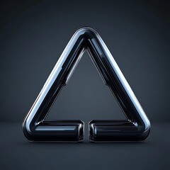 A polished black geometric metal triangle form sits centrally on gray