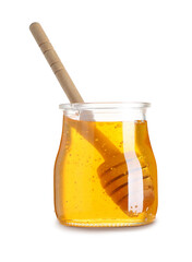 Jar of tasty honey with wooden dipper isolated on white background