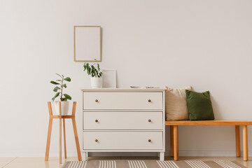Interior of light room with commode, bench and plants