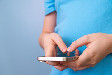 Child using smartphone for gaming or communication close-up