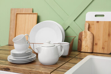 Holder with clean dishes on counter in kitchen