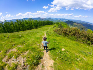 Child hiking in the mountains of mount aldura, basque country