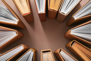 Frame made of books on beige background, closeup