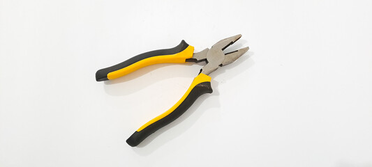 Obraz premium three yellow and black pliers isolated 