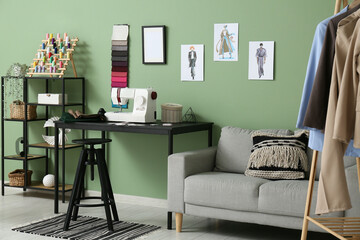 Interior of atelier with tailor's workplace, sofa and shelf unit
