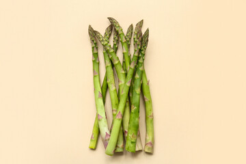 Fresh green asparagus on beige background
