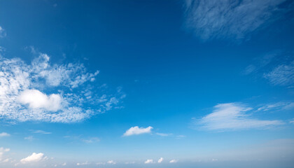 a serene scene of clear blue skies with wispy white clouds peacefully drifting in the airy atmosphere creating a tranquil copy space image