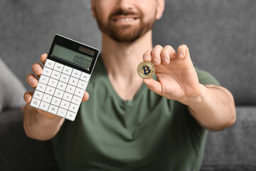 Young man with bitcoin and calculator at home, closeup